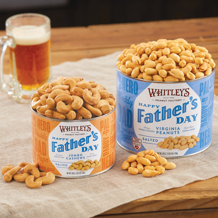 40 oz. Tin Salted Virginia Peanuts Tin and 18 oz.  Tin Salted Jumbo Cashews on a wood table with a glass of beer in the background